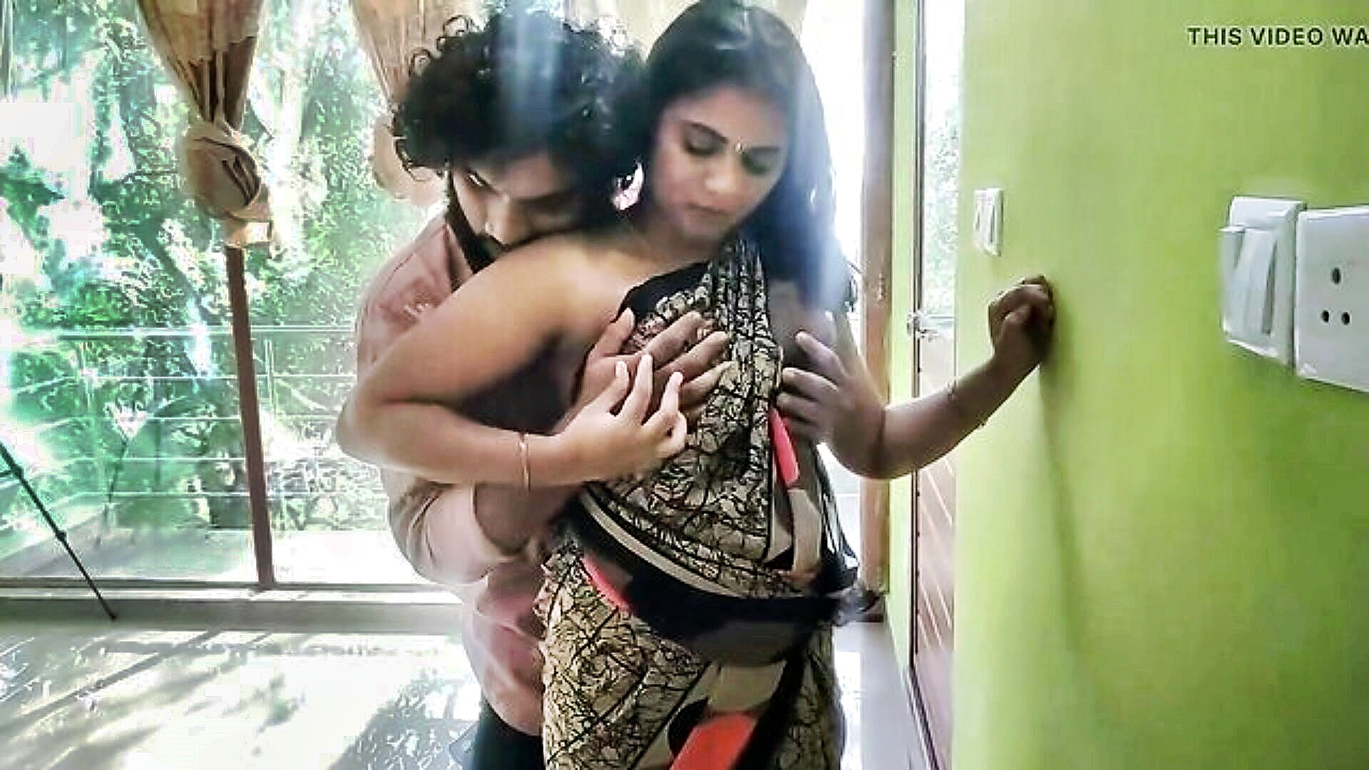 A desi bhabhi in a yellow saree engaging in a sexual act