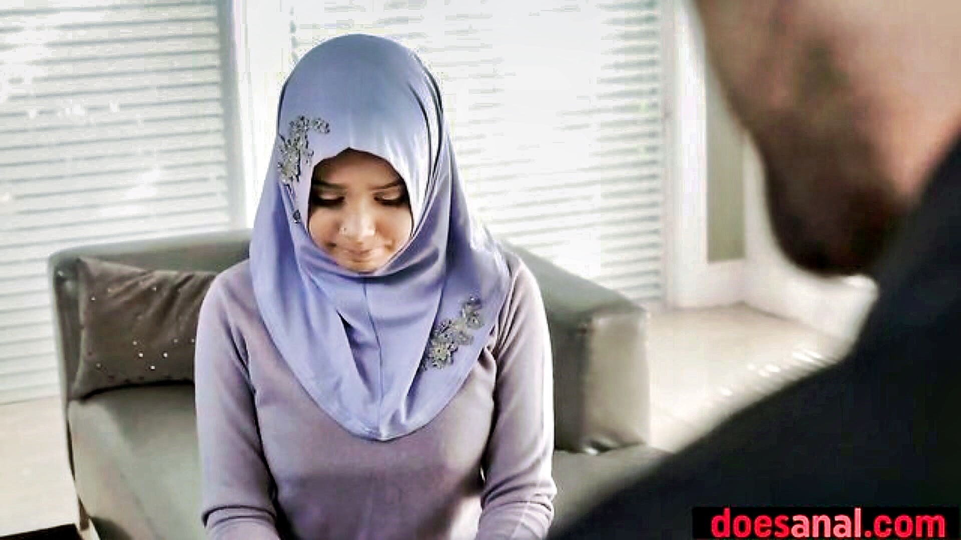 A Muslim woman in a hijab, completely lost in the moment